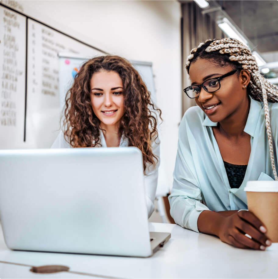 two women sharing a labtop (1)